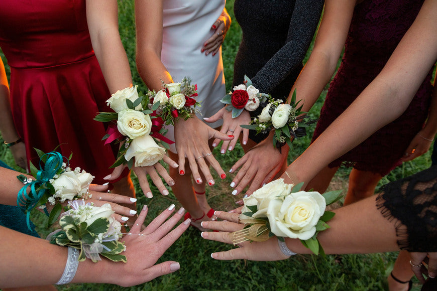 A-circle-of-wrist-corsages-before-a-school-prom-dance.-Beautiful-group-of-girls-wearing-traditional-flowers-at-the-homecoming-dance