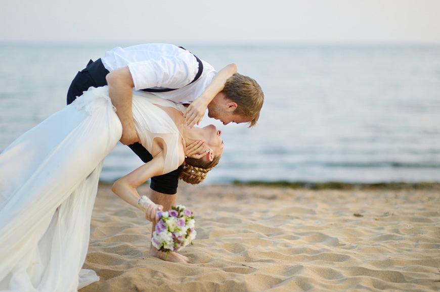 Beach-wedding-bride-and-groom-hugging-by-the-sea