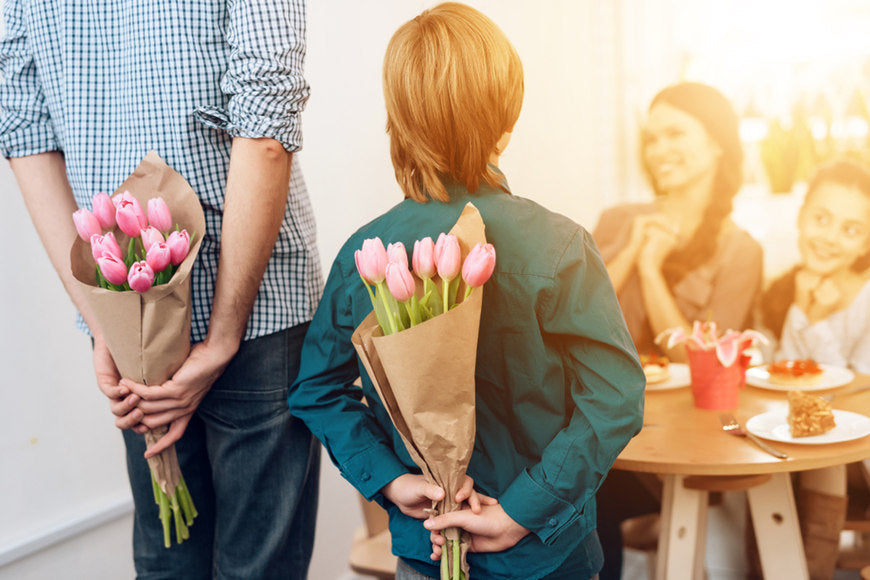 A-man-and-a-boy-give-flowers-to-girls-on-women's-day