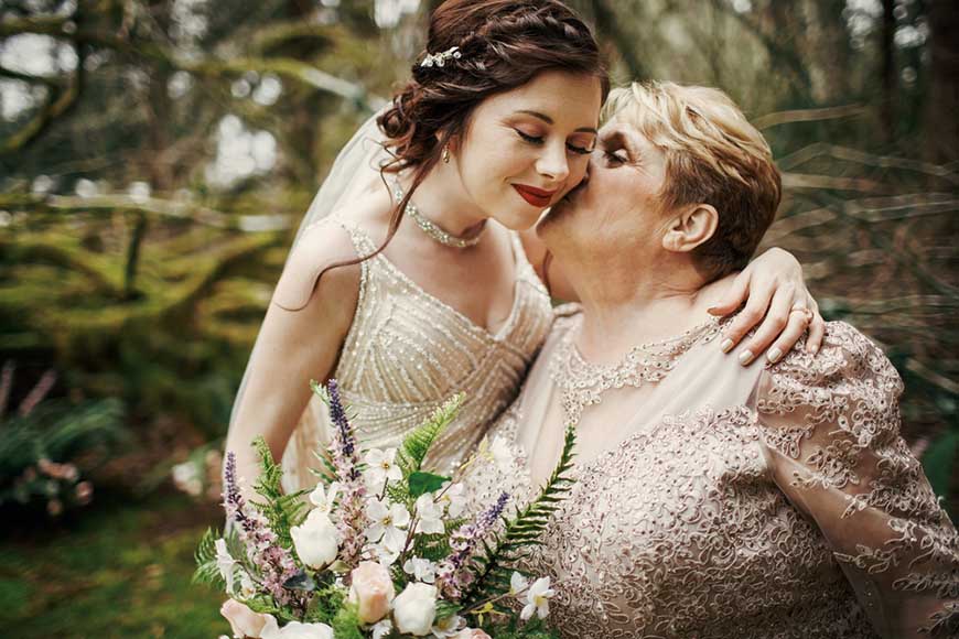 a-mom-is-kissing-her-bride-daughter