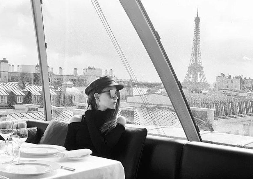 a-woman-wears-sunglasses-and-baker-boy-cap