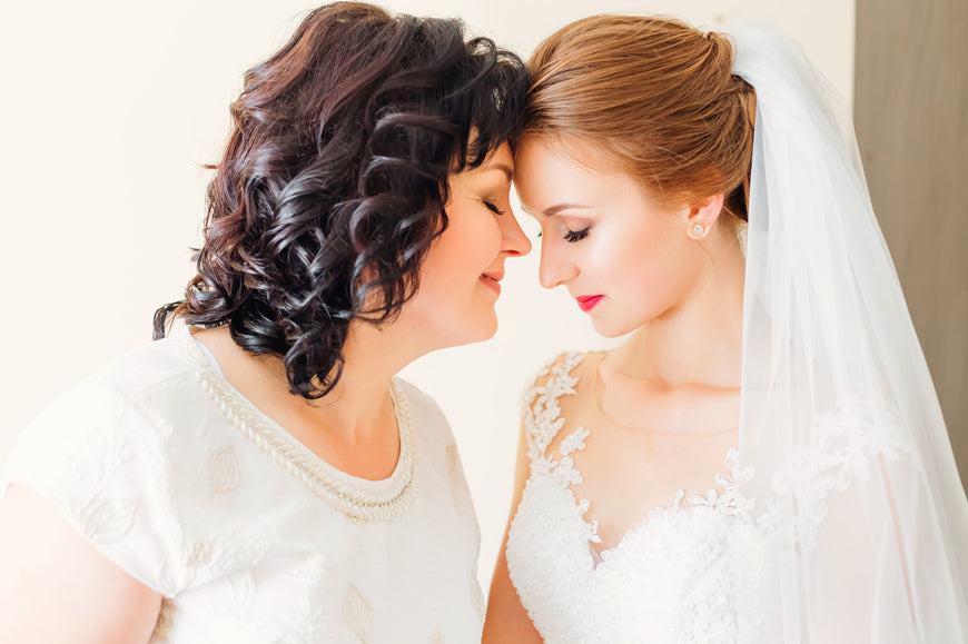 tender-Bride-and-Mom-hug-and-touch-their-foreheads-on-the-wedding-day